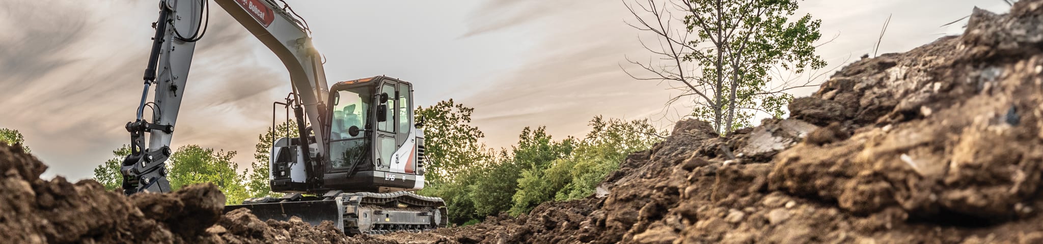 Bobcat E145 by a Dirt Pile After a Successful Workday 