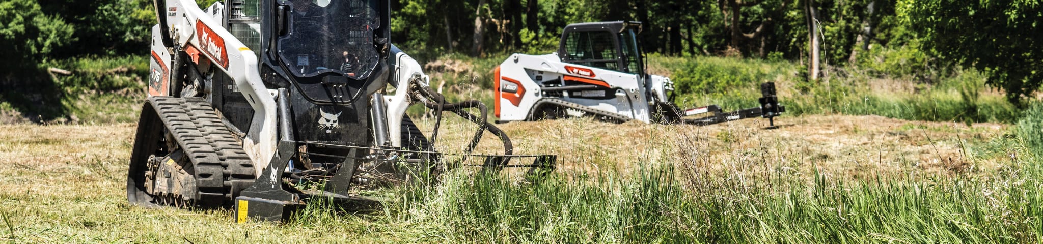 A Bobcat T76 With Brush Cutter Attachment Cuts Down Tall Vegetation 