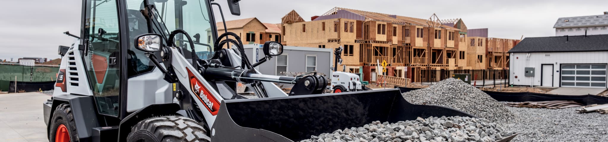 Bobcat L95 Compact Wheel Loader Carrying Big Pile of Rocks