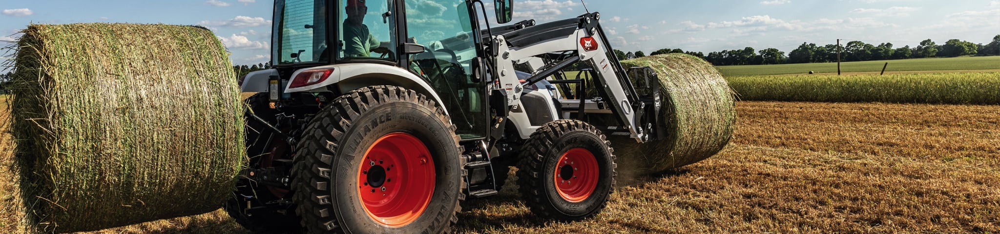 Operator Moves Bales in a Field Using a Bobcat UT6573 Utility Tractor  