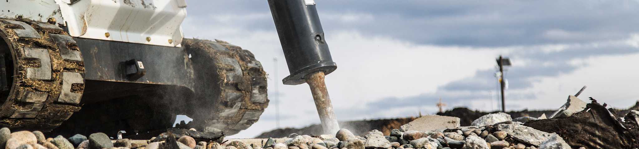 A Close-Up of a Bobcat T740 and Breaker Attachment at Work