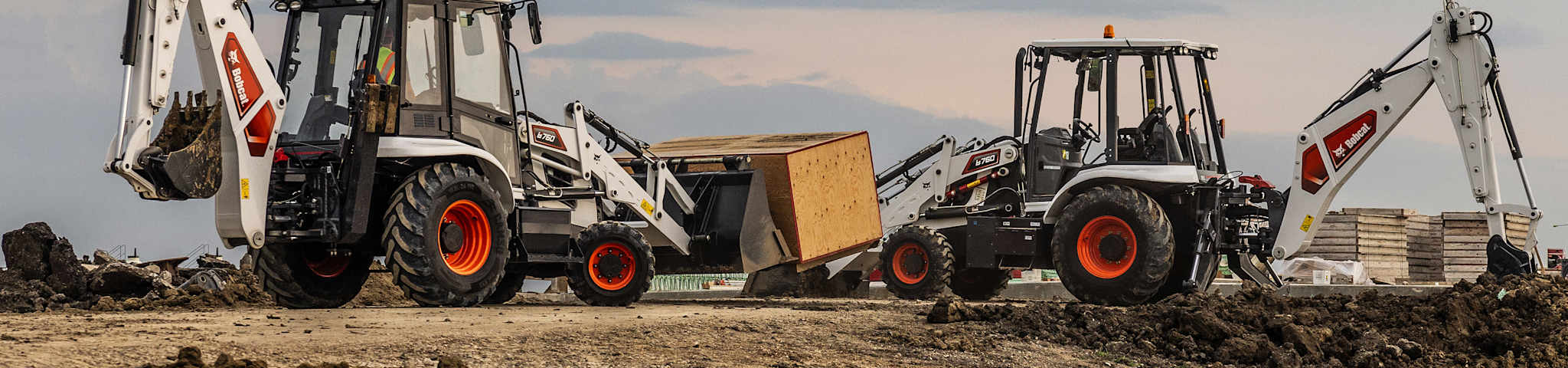 Two Bobcat B760 Backhoe Loaders Work on a Jobsite