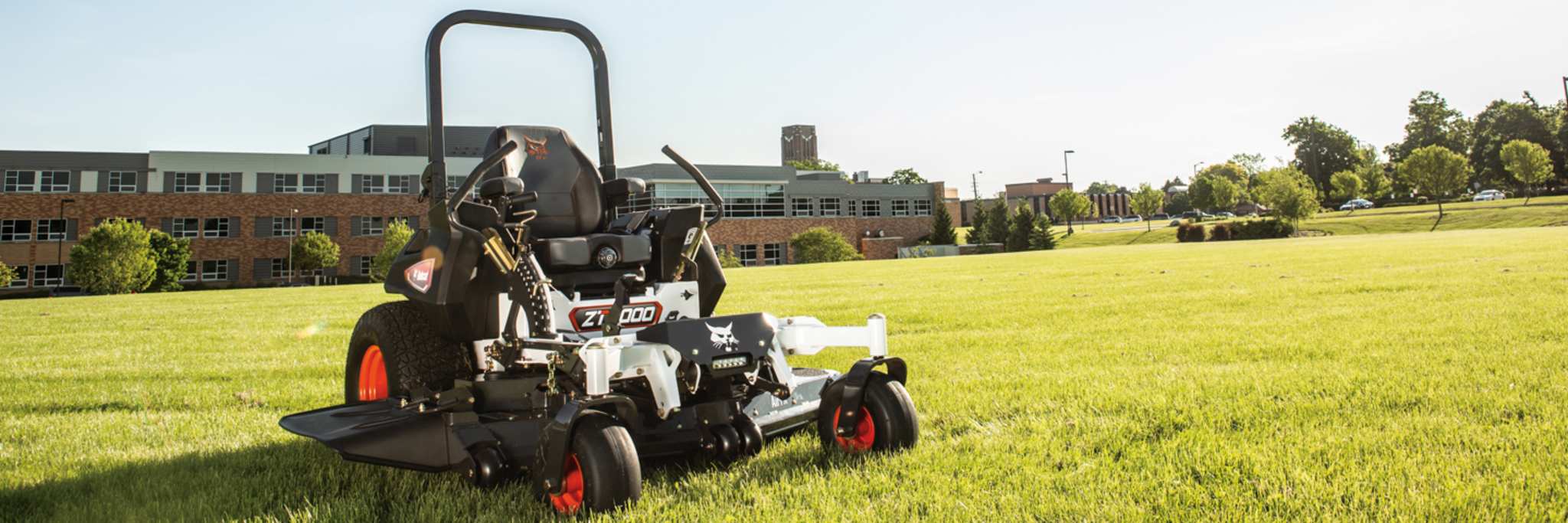 Bobcat ZT7000 Zero-Turn Riding Mower Sitting in Field in Front of Building