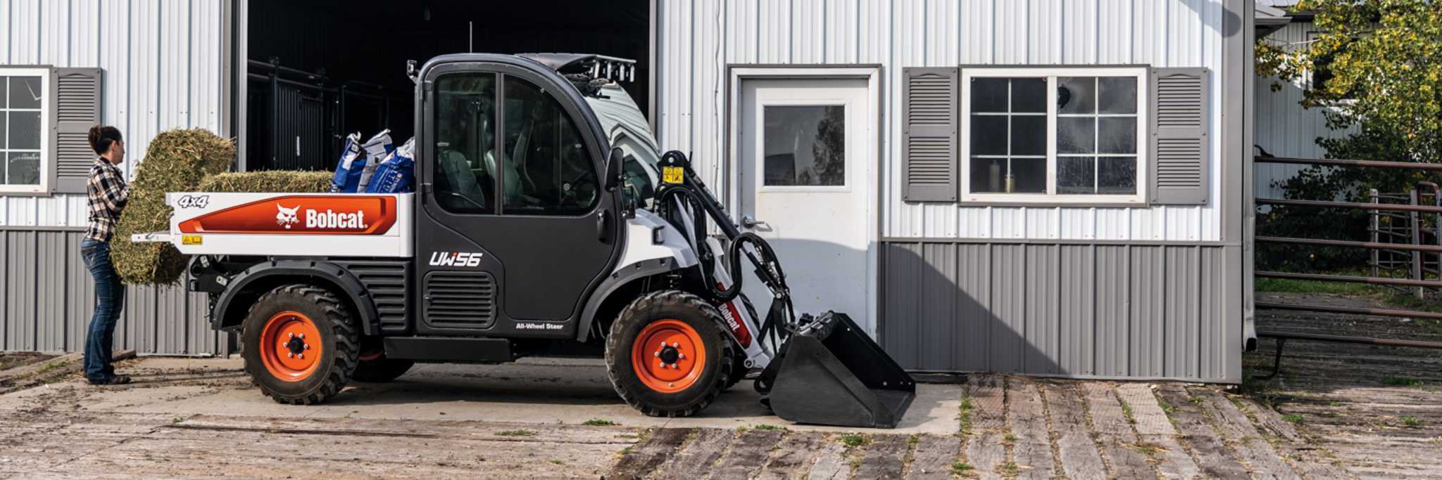 Operator Loading Hay Into Bobcat UW56 Toolcat Utility Work Machine Flatbed