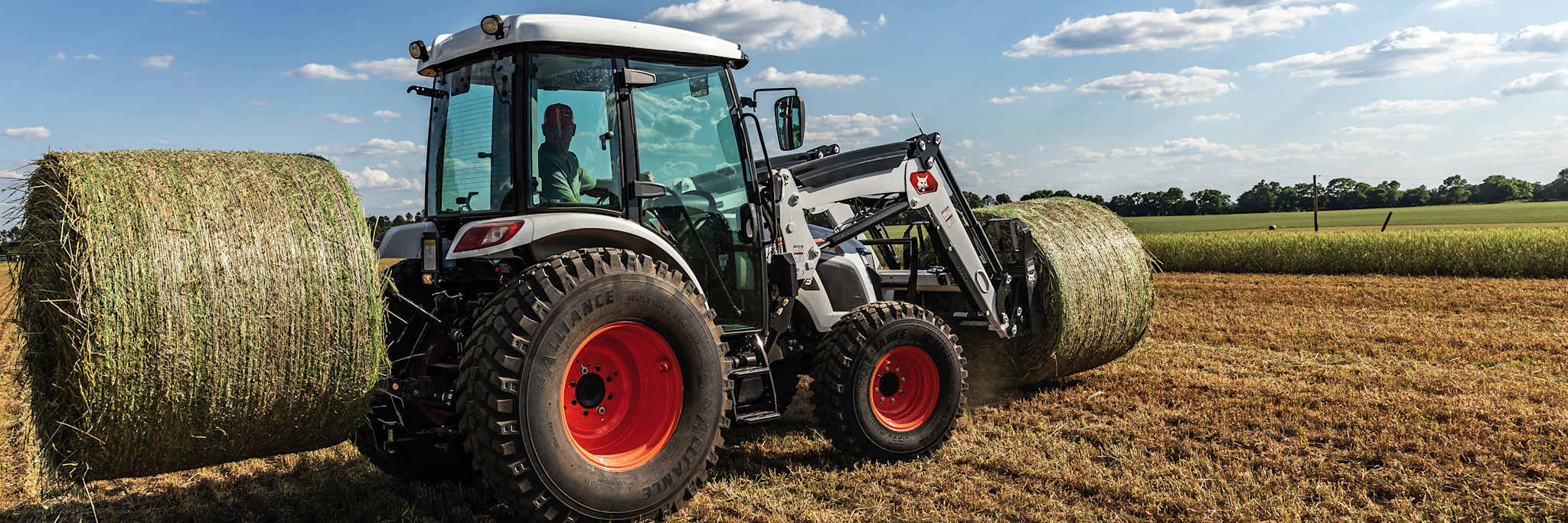 Bobcat UT6573 Utility Tractor Carrying Two Hay Bales With Bale Spear on Front