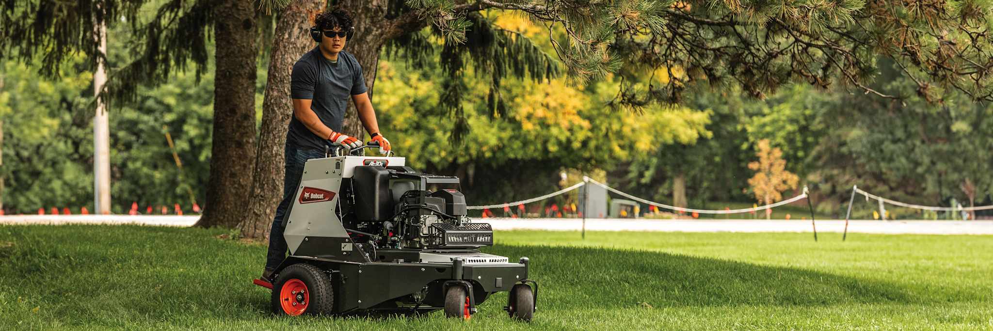 Operator on Bobcat AE30s Aerator Aerating Lawn