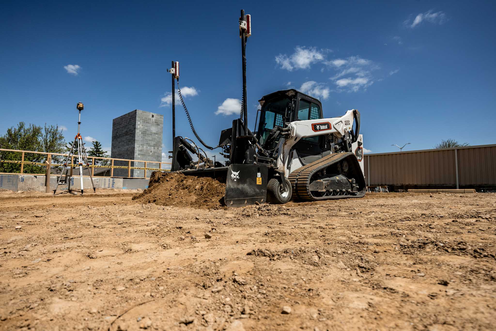 Bobcat Pro T86-2 Compact Track Loader With a Heavy-Duty (HD) Box Blade Attachment Grading Soil at a Construction Site