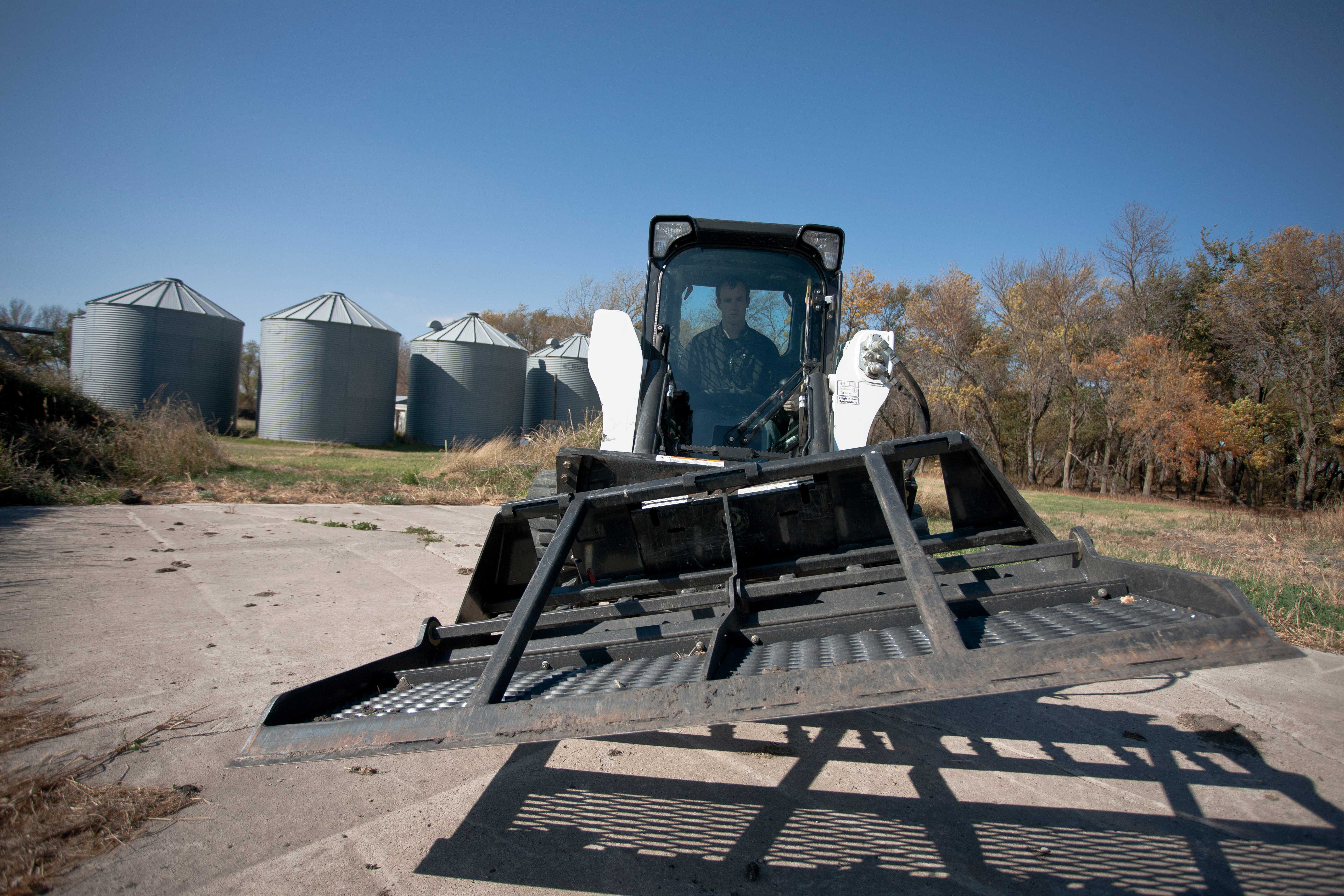 A Bobcat Skid-Steer Loader Angles a Landplane Attachment Using a Tilt-Tatch