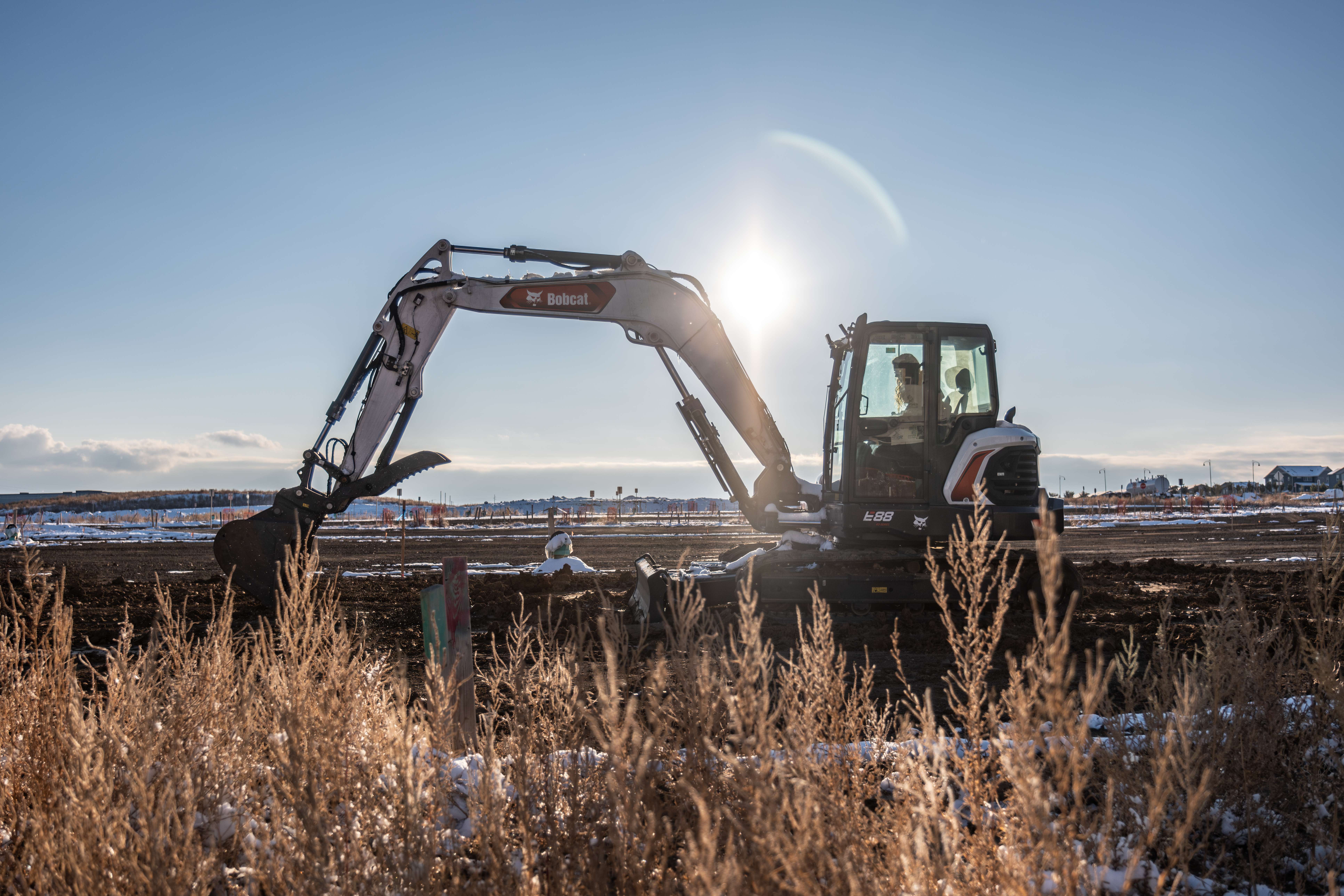 Bobcat 7–8 ton compact excavator working on a large construction site