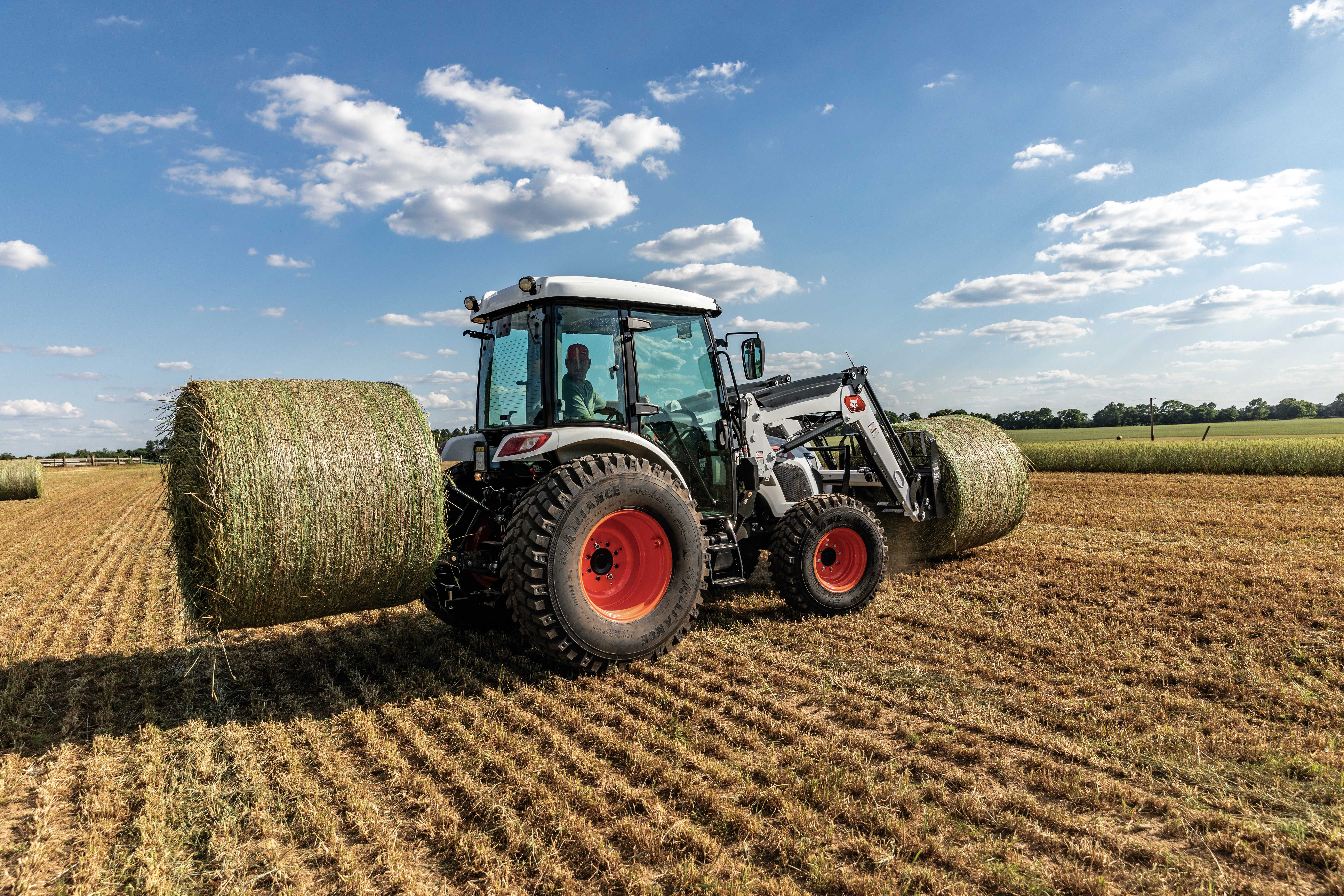 A Bobcat UT6573 Utility Tractor Handling Hay With the Bale Spear Attachment