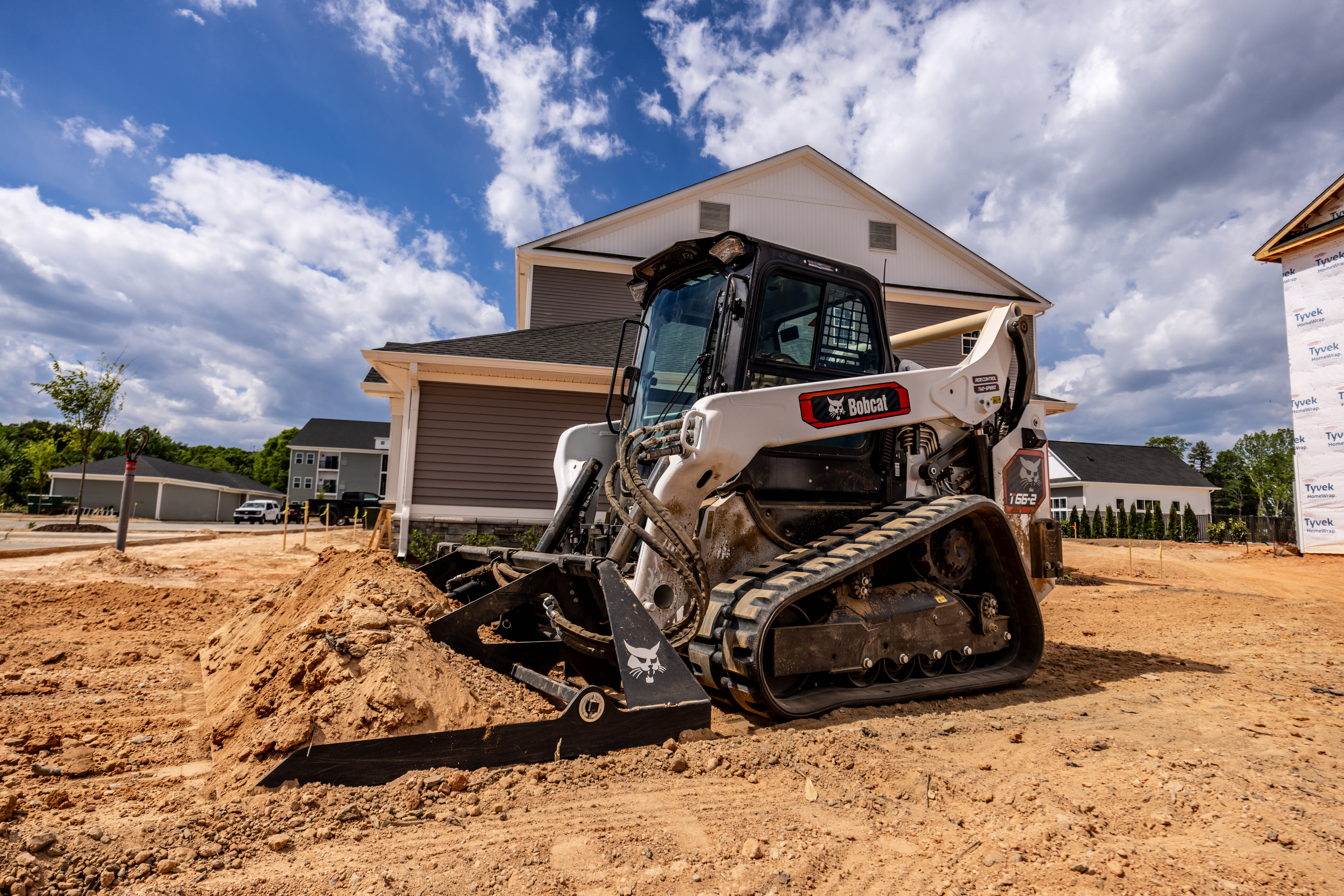 Bobcat Pro T66-2 Compact Track Loader With Landplane Attachment Grading Dirt at a Residential Construction Site