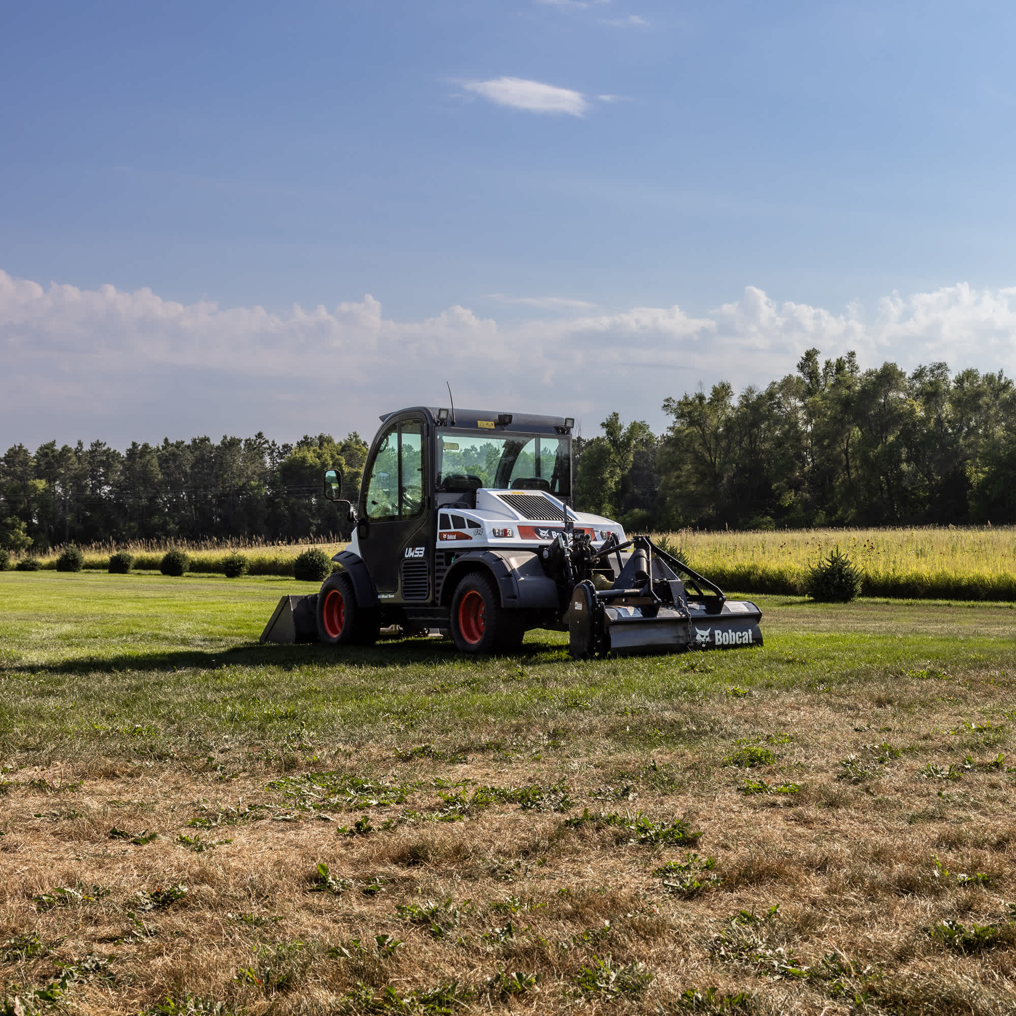 Stationary Bobcat UW53 and UW 56 Toolcat machines in a field