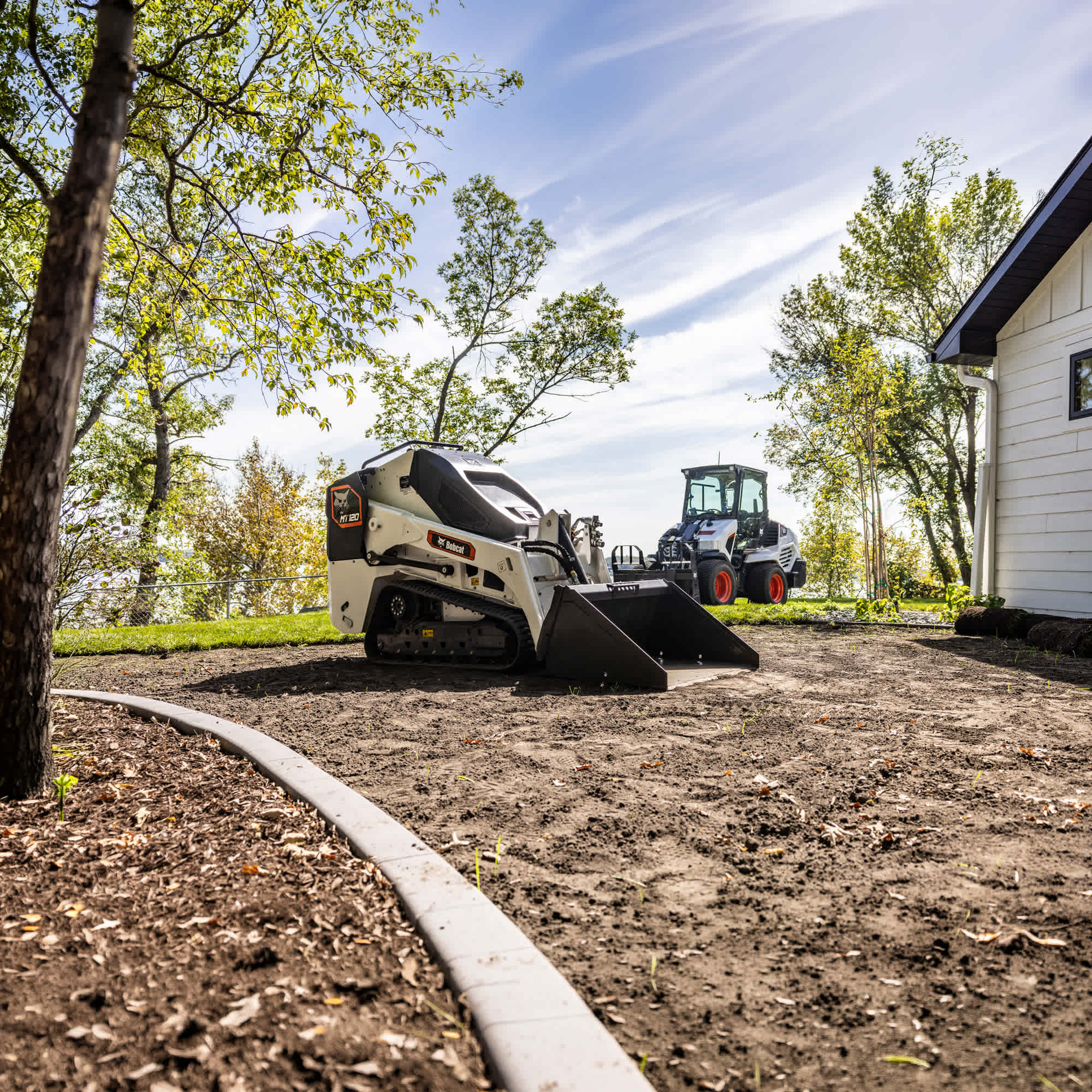 A Bobcat MT120 Mini Track Loader with 36" bucket at a landscaping site