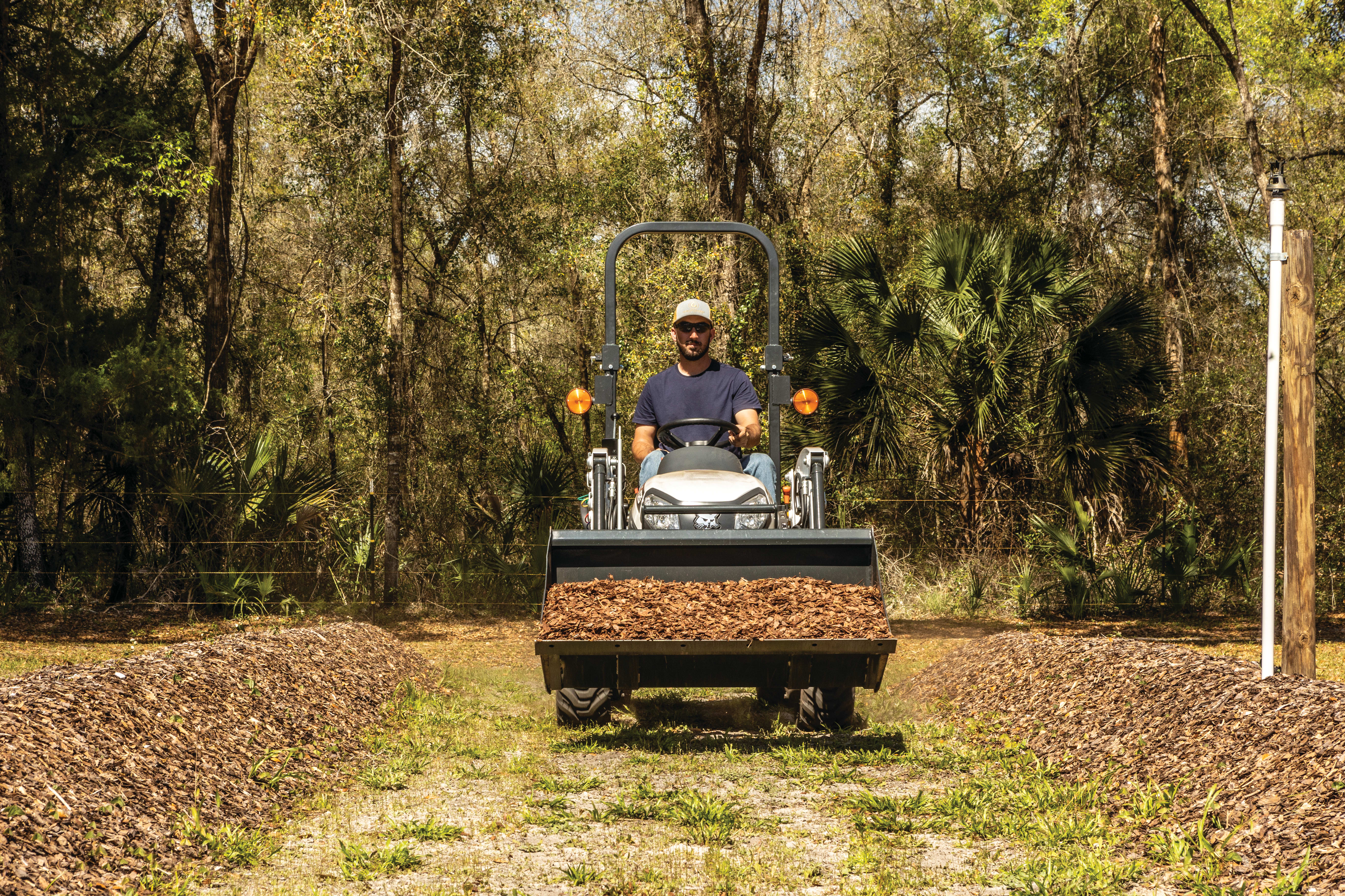 Small tractor with belly mower outlet