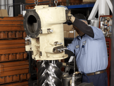 factory worker fixing an airend