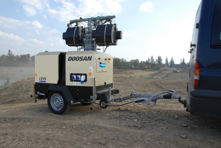 a group of light towers on a construction site