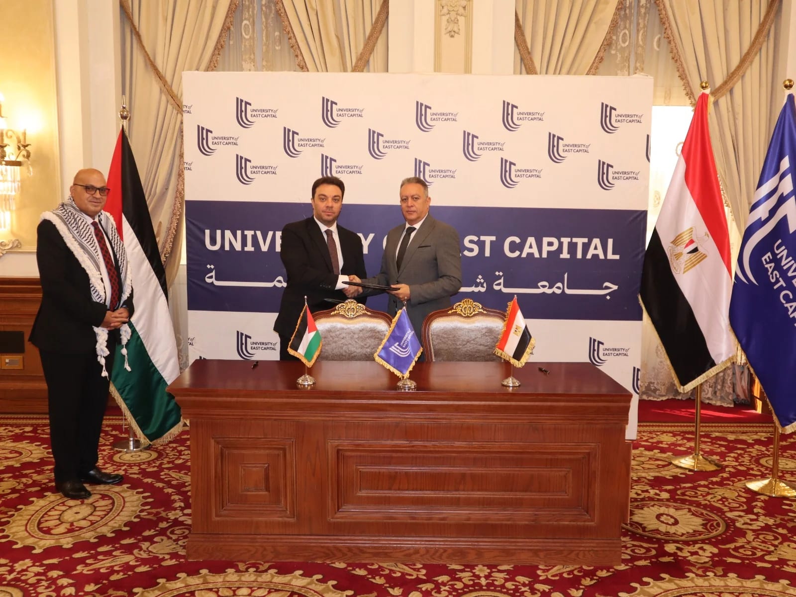 Prof. Dr. Ayman Diab, Ambassador Nagi Al-Nagi, and Salim Al-Talouli holding the signed cooperation agreement