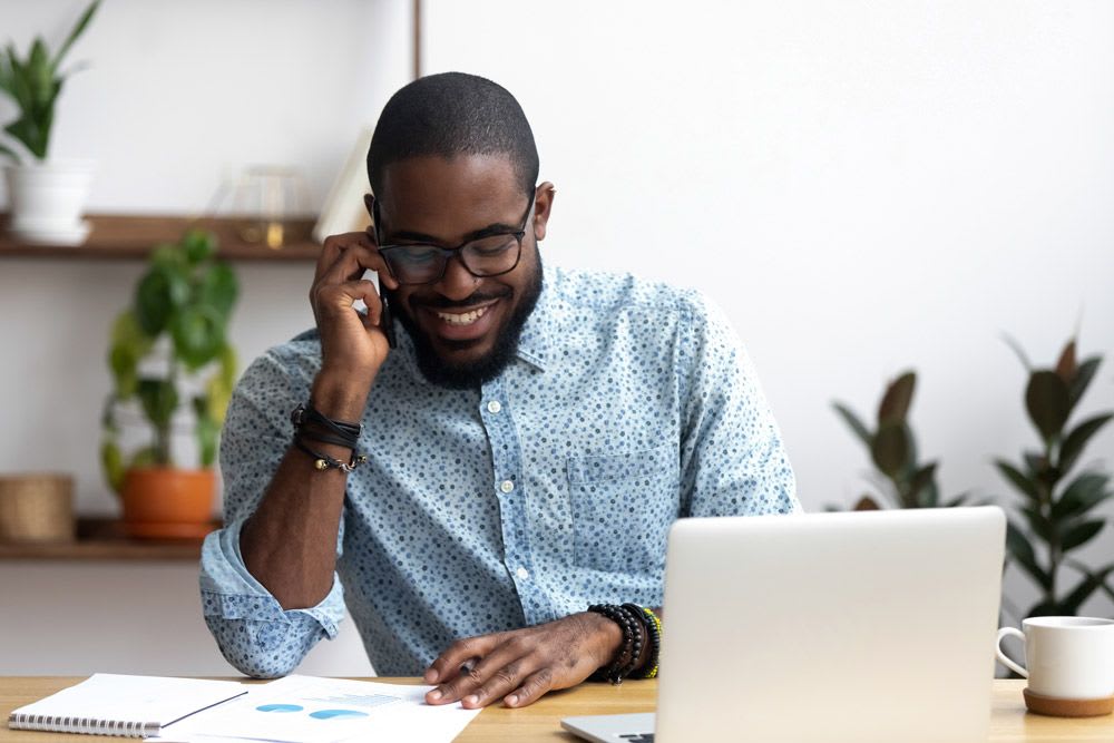 A business professional receiving technical help over the phone