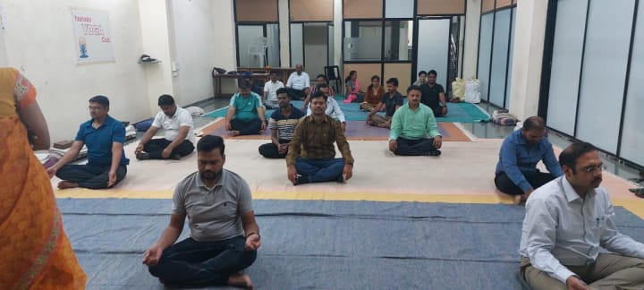 Students practising seated yoga together in a studio