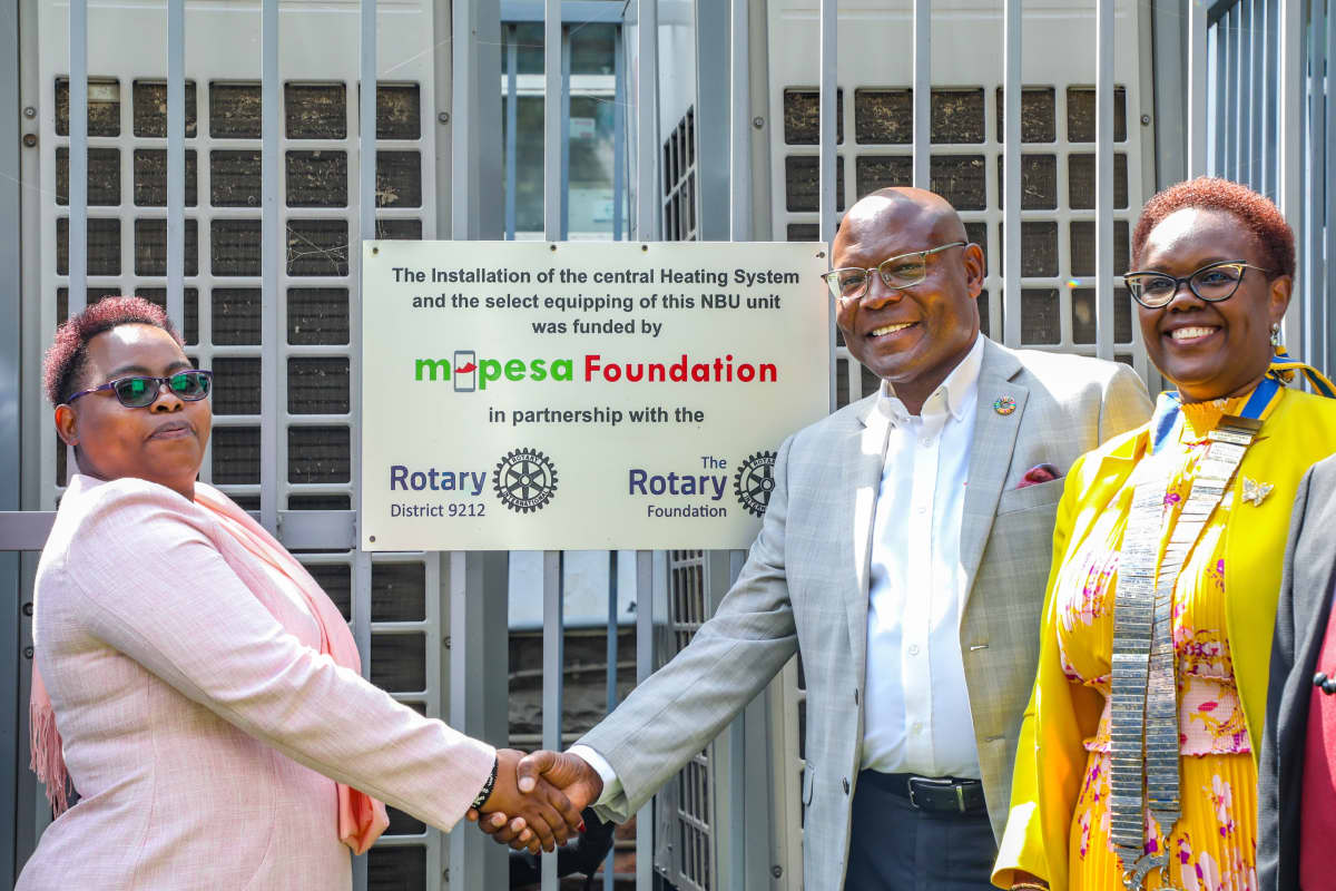 Pumwani Maternity Hospital CEO Christine Kiteshuo (left) receives a central heating system and newborn unit equipment from Safaricom Foundation Chairman Joseph Ogutu and Rotary District 9212 Governor Wairimu Njage during a handover ceremony at the hospital.