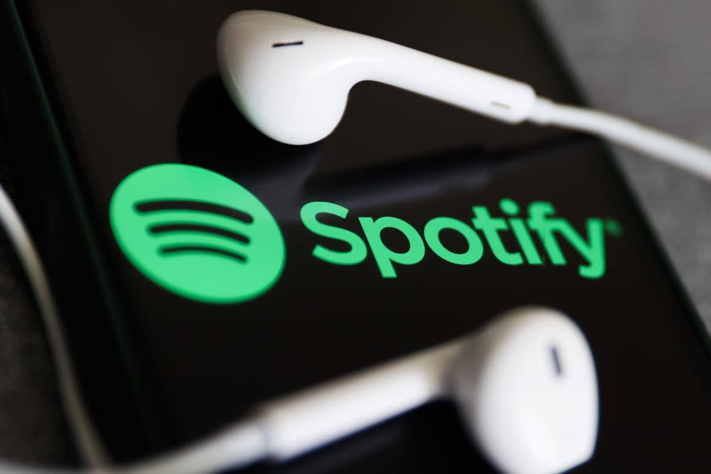 A photo of a pair of earphones and a phone logged into Spotify. /VARIETY