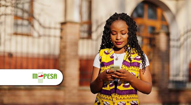 Photo of a woman using her phone and a logo of MPESA. /FINTECH NEWS AFRICA