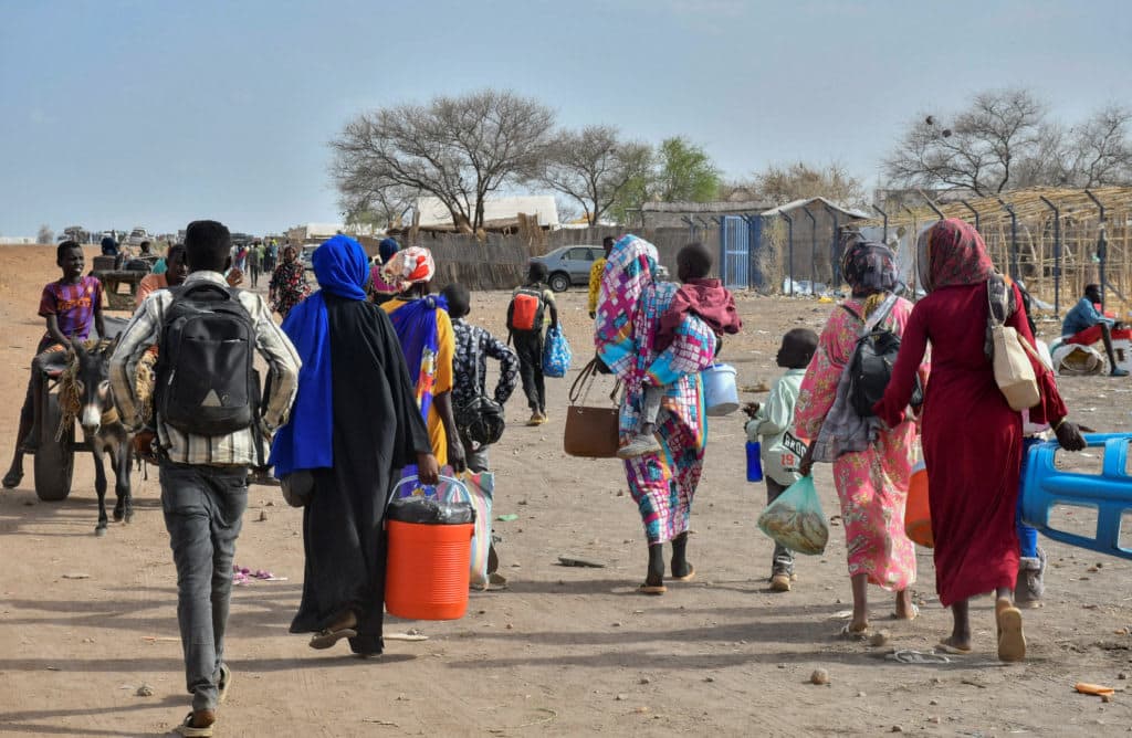 Civilians who fled the war-torn Sudan following the outbreak of fighting between the Sudanese army and the paramilitary Rapid Support Forces (RSF) walk at the Joda South border point, in Renk County, Upper Nile state, South Sudan, April 30, 2023. /PBS NEWS.REUTERS