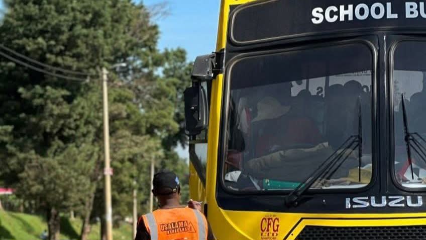 Photo of an NTSA official inspecting a school bus. /NTSA