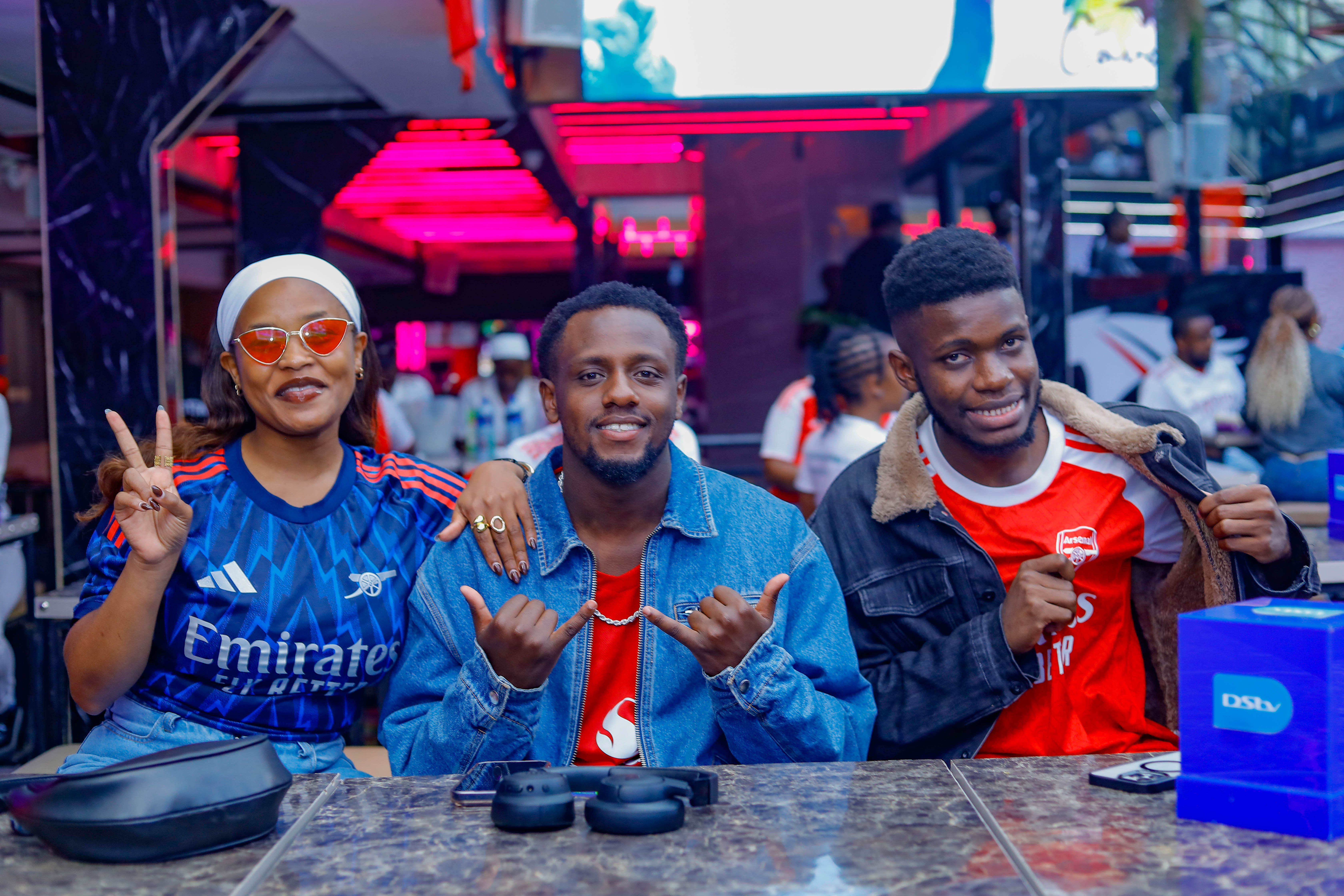 (L-R) Christine Irungu alias Kriss Babby, Content Creator; Tony Mwirigi alias Comedian Mwirigi, Digital Content Creator; and Bradley Ochieng', Social Media Executive at MultiChoice Kenya, pose for a photo during The Gunners Parade Watch Party at Cavalli Restaurant & Lounge.