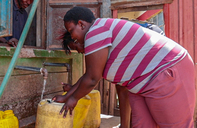 Photo of a woman fetching water. /SAFARICOM NEWSROOM
