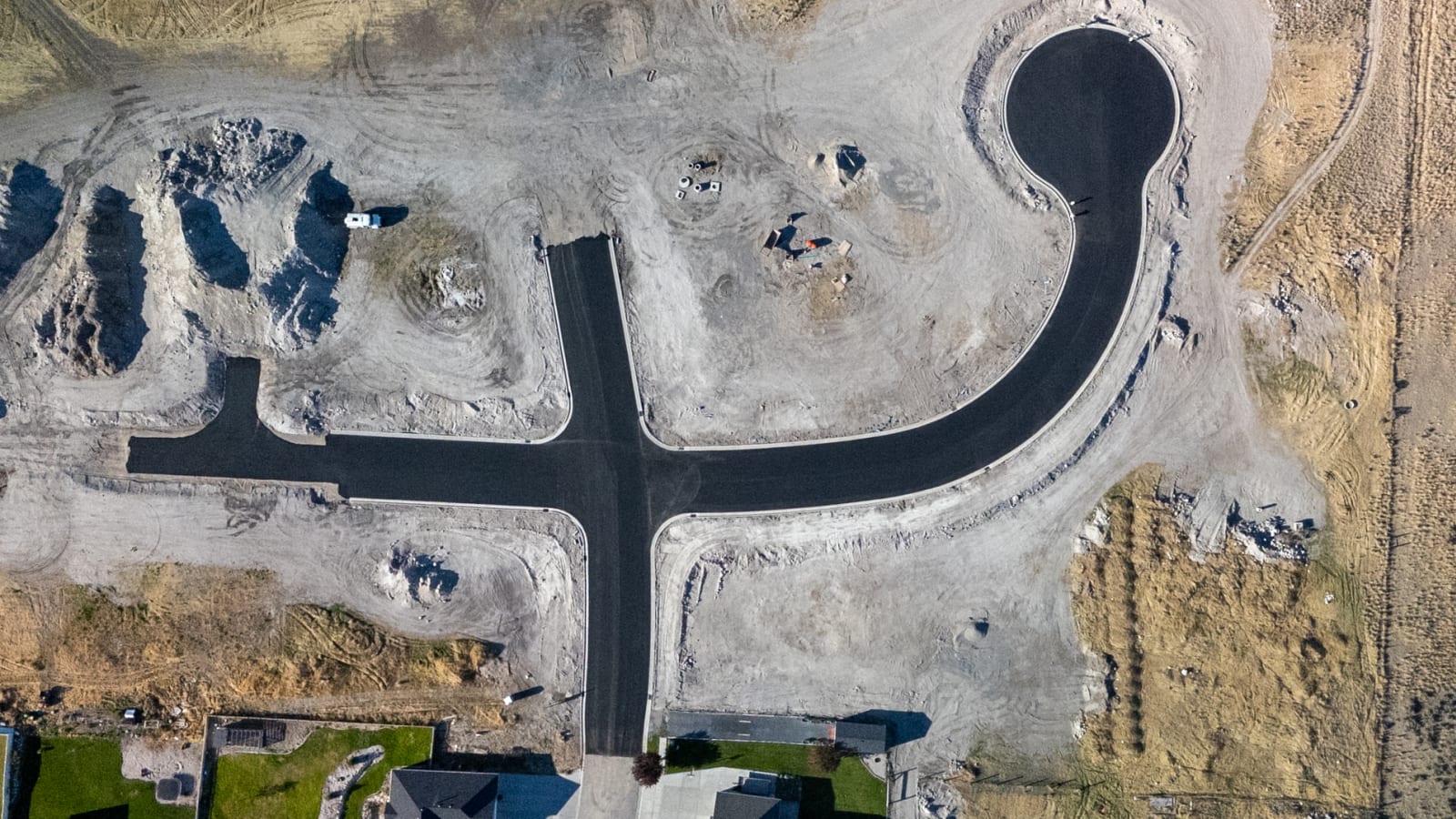 After: subdivision roads rough graded before and paved with curb after