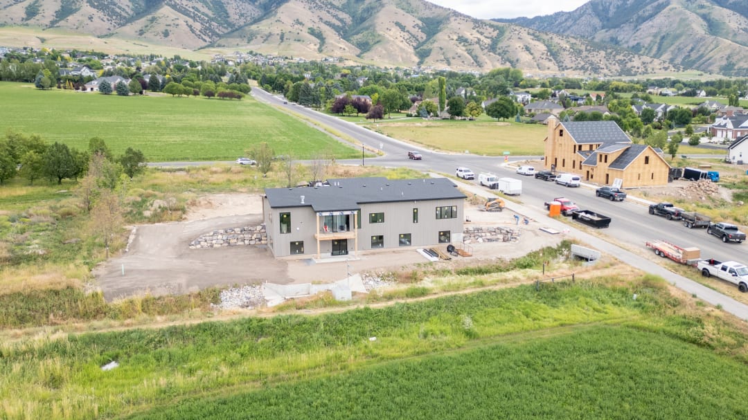 Drone view of the same home after the lot was cleared and graded