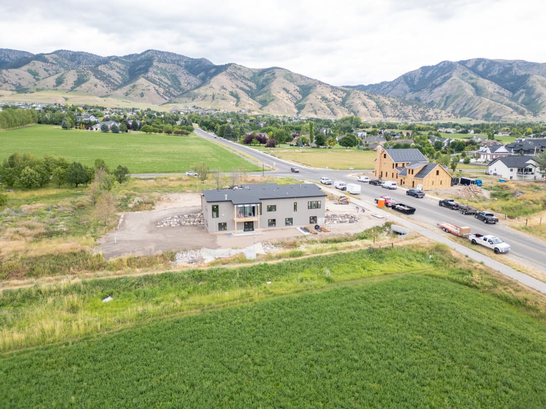 Drone view of the same home after the lot was cleared and finish graded