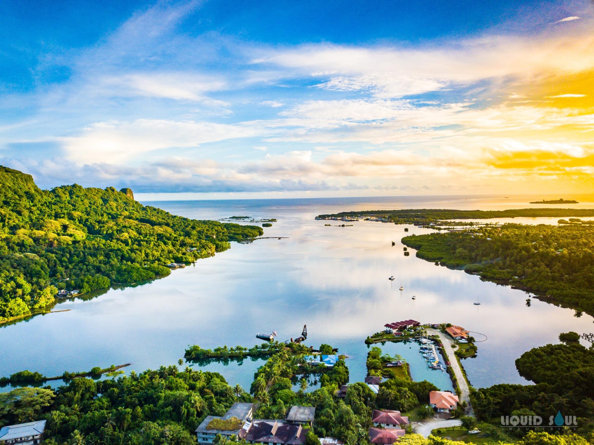 Pohnpei’s forested lagoon shores opening toward the Pacific at sunset