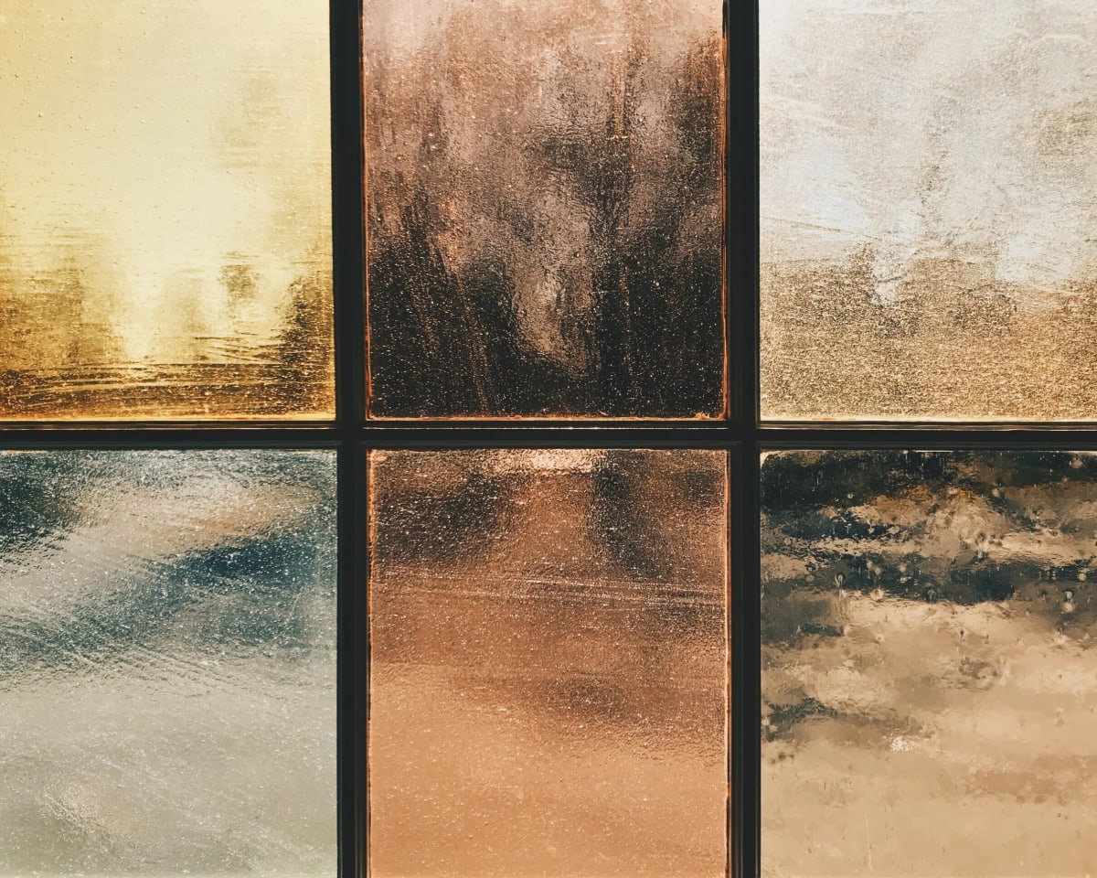 Abstract image with six panels of different textures and warm tones.