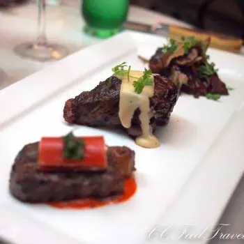 Braised Beef Cheek, Wild Mushroom Confit, Beef Jus Grilled Australian Angus Beef Ribeye; Braised Shallots, Cabrales Cheese Sauce; Master Kobe Sirlion, Tomato and Goat Cheese Cannelloni, Red Pepper Oil.