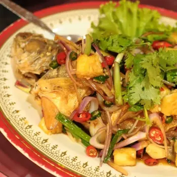 Deep fried fish with topping of chilly, pineapple and serai