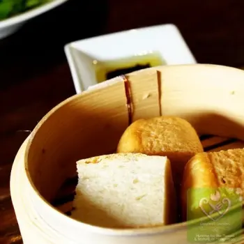 Self Baked Bread Served In A Chinese Bamboo Steamer With Olive Oil And Balsamic Vinegar