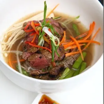 Grilled Beef And Ginger Soup With Soba Noodle Is Served With Asparagus Zucchini, Mushroom And Chili Soy Sauce