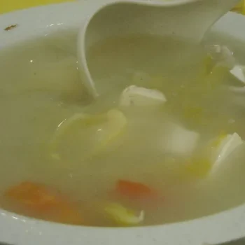 Preserved Chinese mustard soup with White bean curd, strips of lean pork and tomatoes