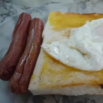 Butter Toast Bread With Runny Fried Egg And Oven Grilled Chicken Sausage