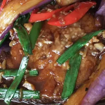 Deep fried fish with brinjal topping