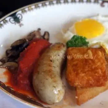 Two Eggs Any Style of bull eyes fried eggs served with beef bacon, breakfast sausage, sauteed mushrooms, stewed tomato, fried farmhouse bread and hash brown.