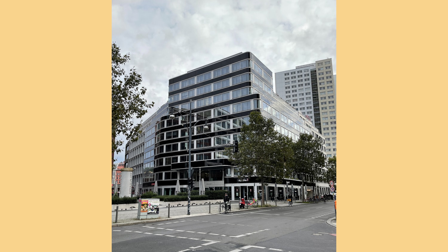 The outside of our Berlin office, a tall building reflecting the green trees surrounding it