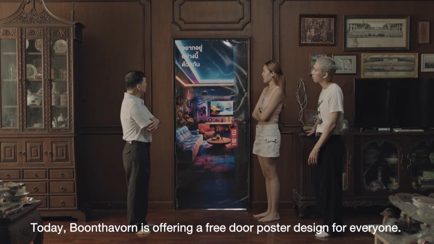 Three customers looking at a poster hung up on door