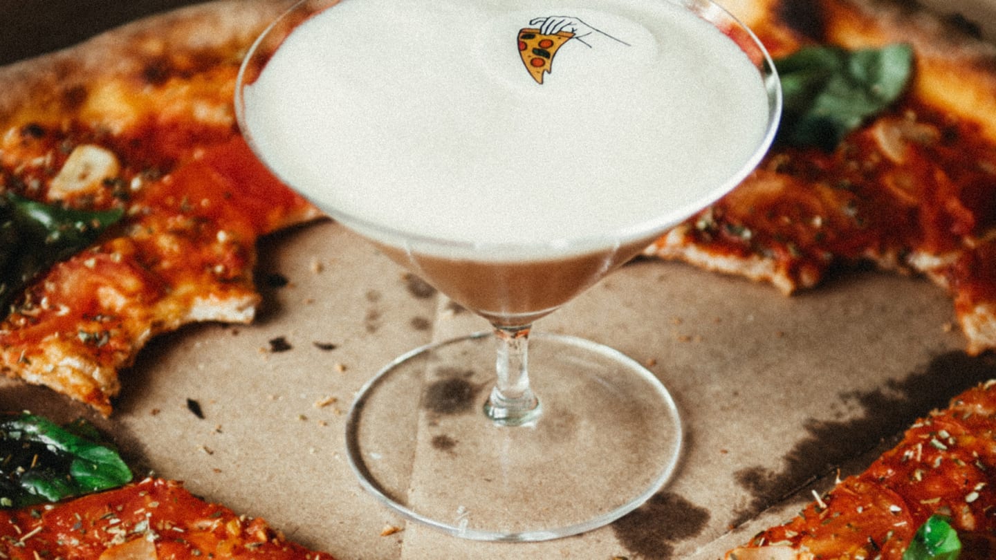 Cocktail surrounded by pizza slices