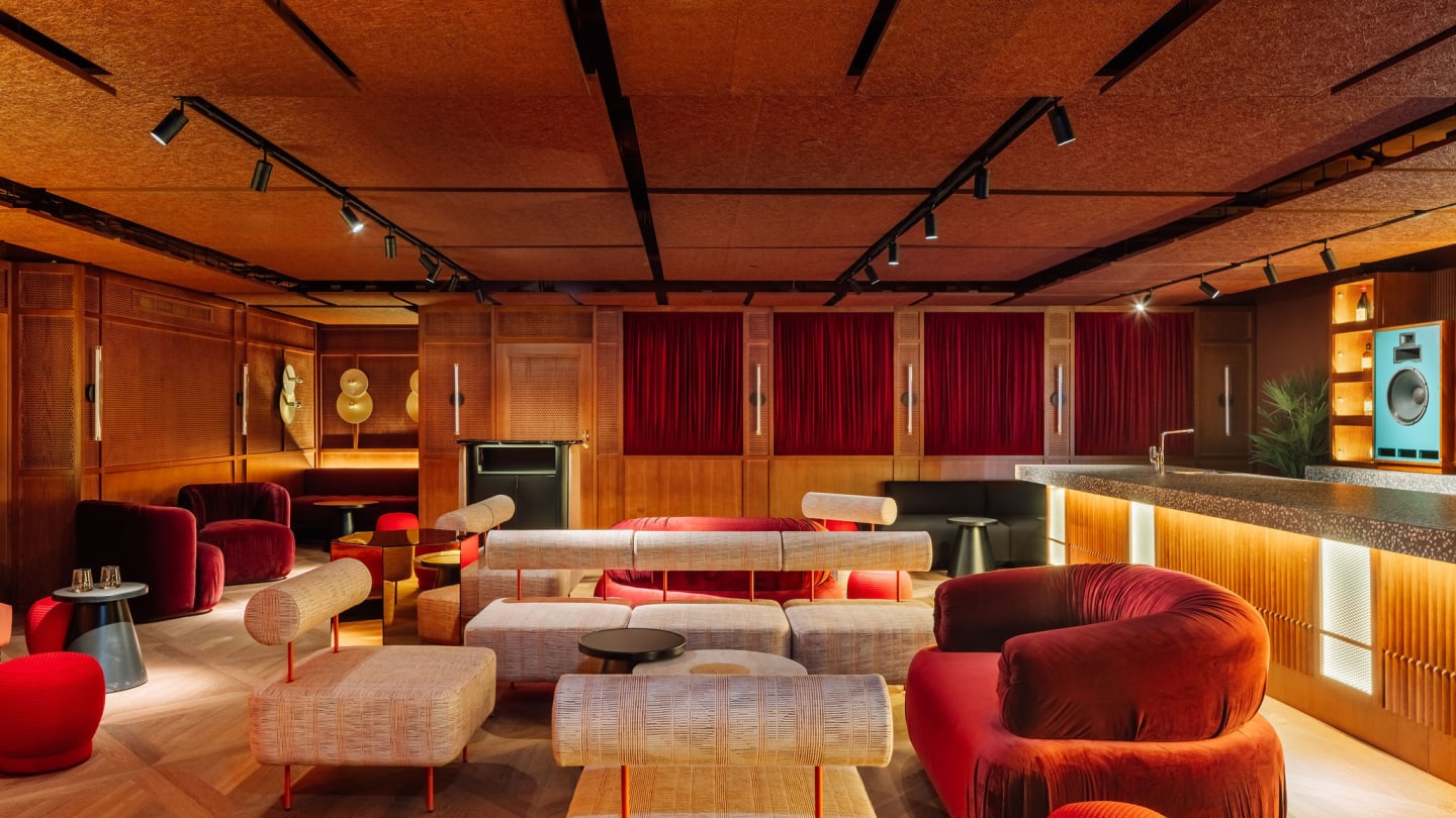 Stylish interior with wood panelled walls sound insulation on ceiling and soft seating areas