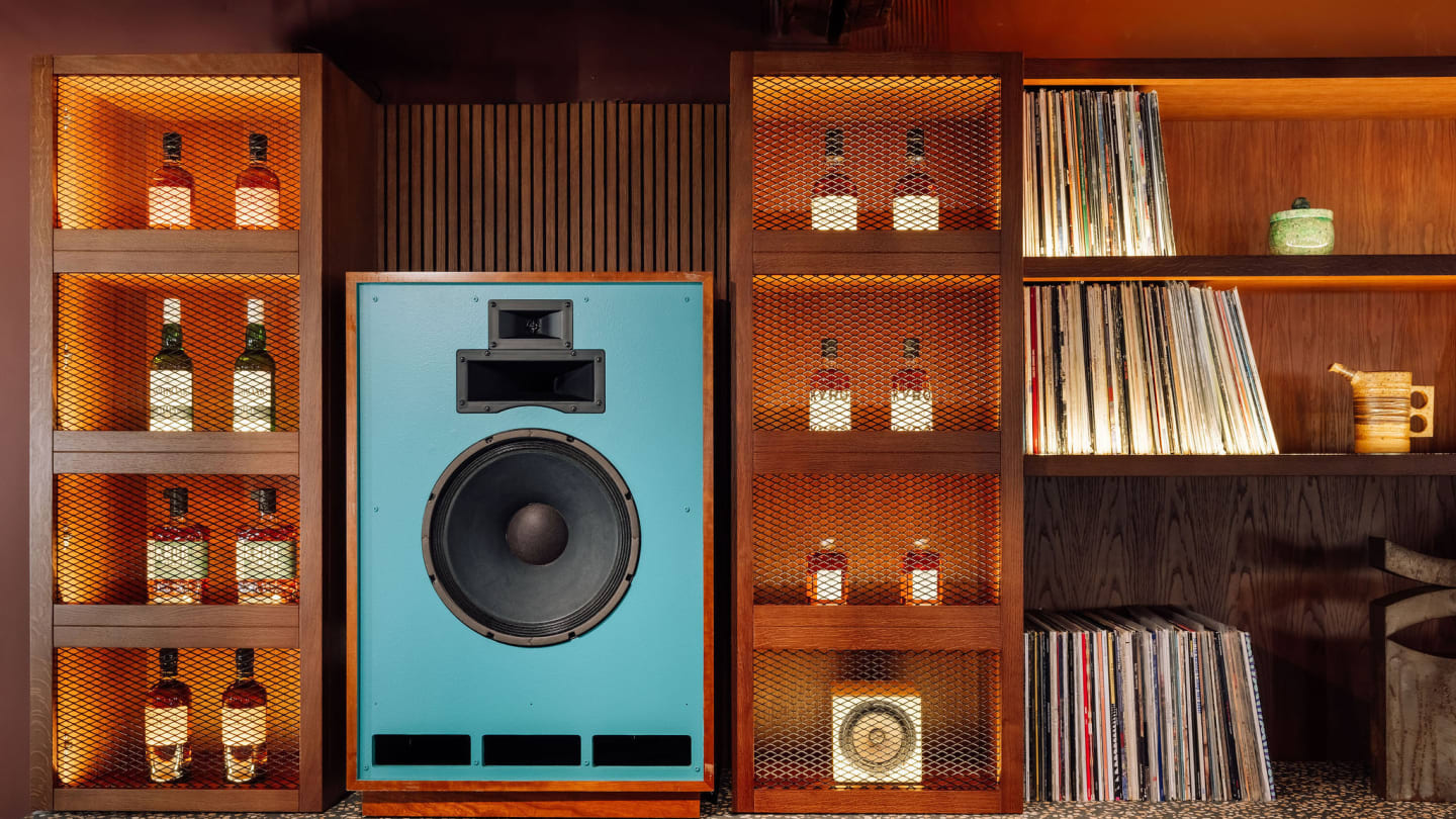 Bar interior at the Kissaten with shelves of whisky bottles alongside vinyl records and large speakers