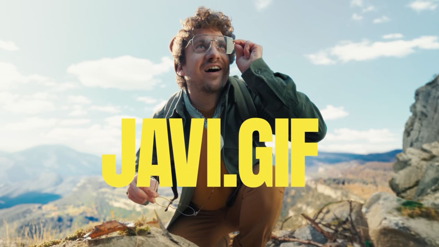 Image of Javi wearing glasses and other pair in his right hand holiding them.