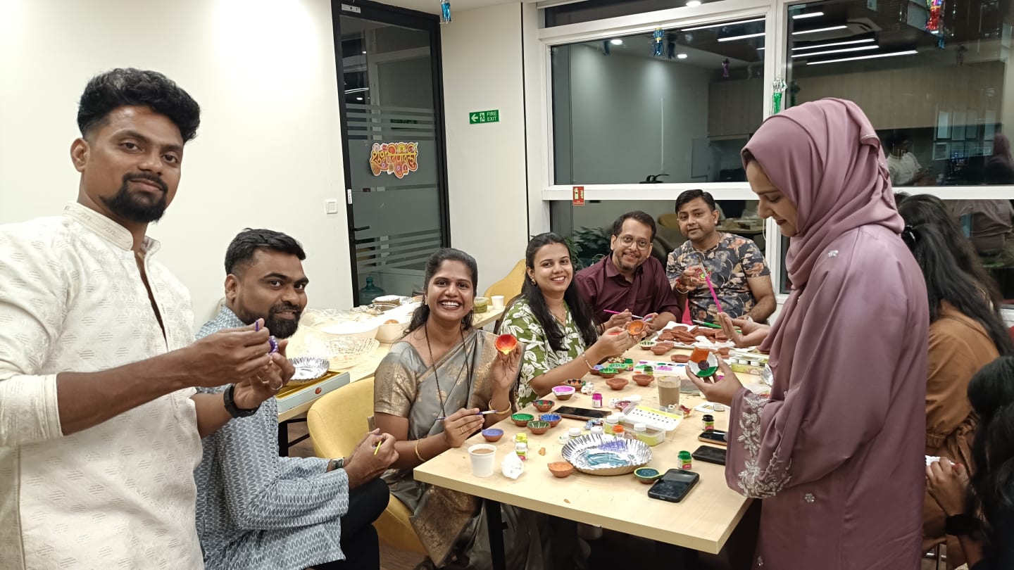 VML Enterprise Solutions Mumbai employees celebrating Diwali by painting diyas.